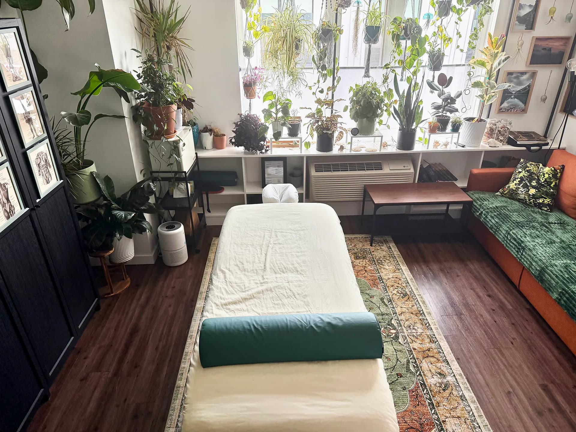 View down the massage table toward the plant-filled window in the Portland studio